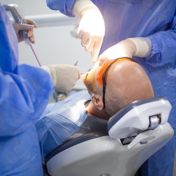 A wisdom tooth extraction surgery in progress in a dental hospital.